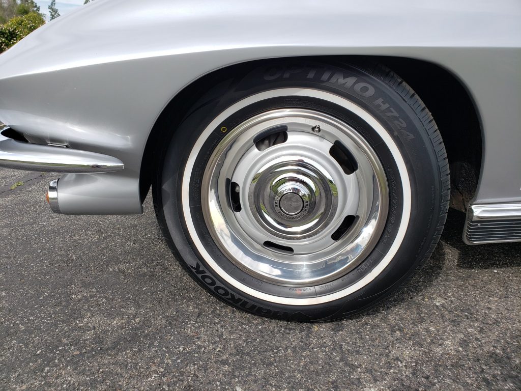 The wheels of this 1966 Corvette are wrapped in whitewall Hankook tires.