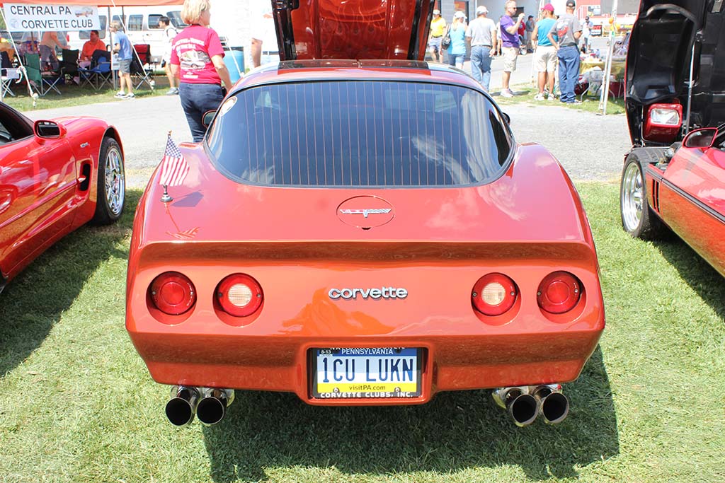 Orange C3 corvette with vanity plate