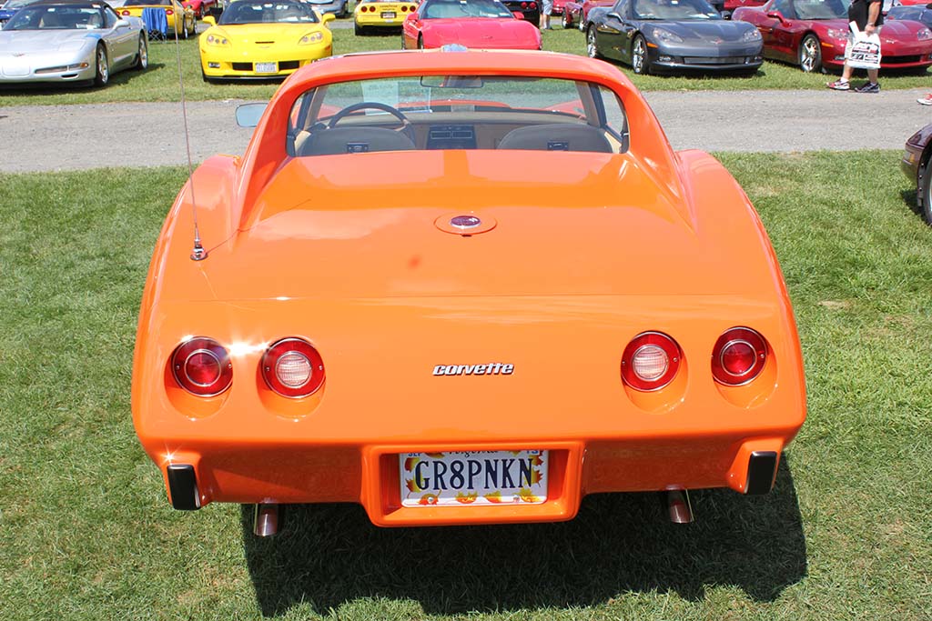 Orange C3 corvette with custom plate