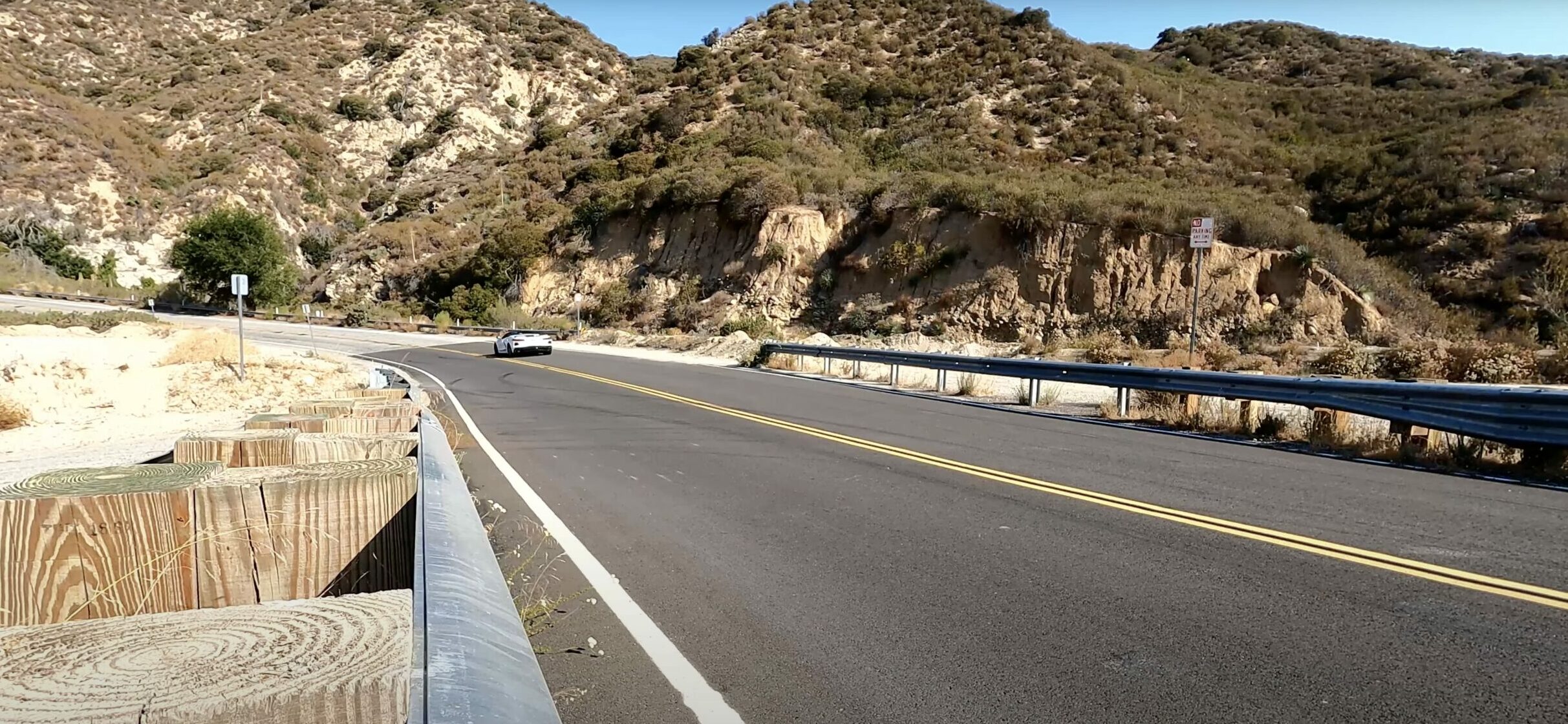 a View of the 2021 C8 Corvette 3LT Z51 driving down a highway on a hot sunny day