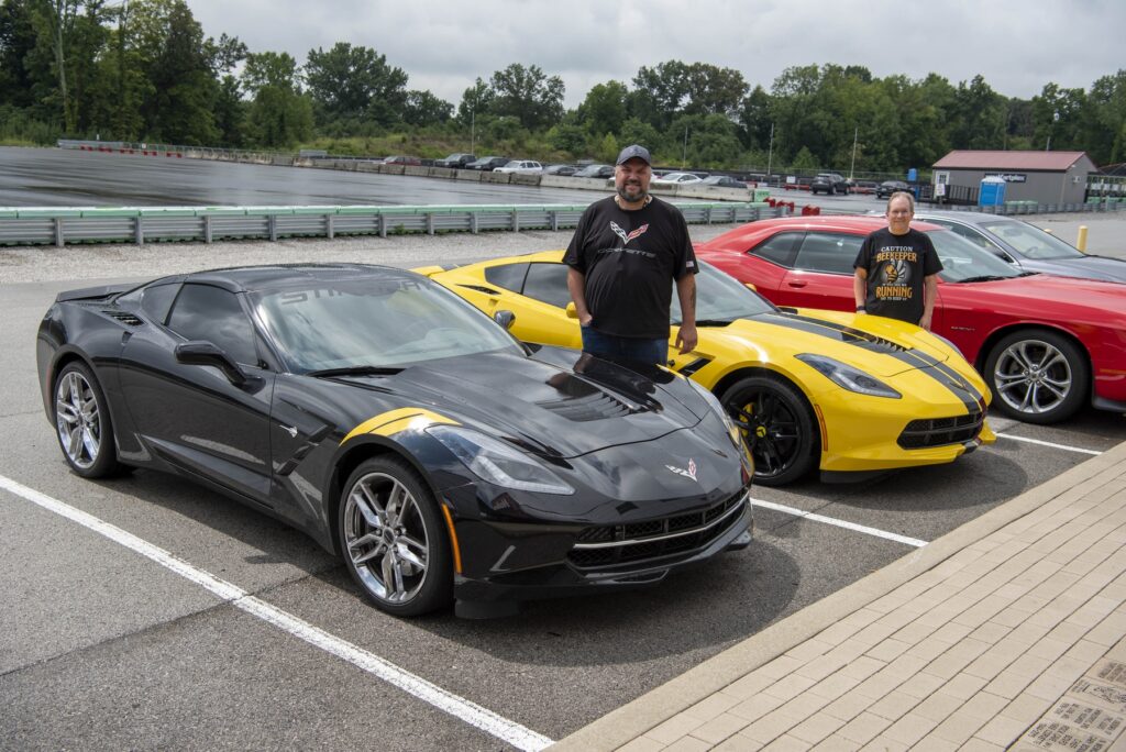 Scott (left) and Cliff with their C7 Stingrays at the NCM Motorsports Park track.