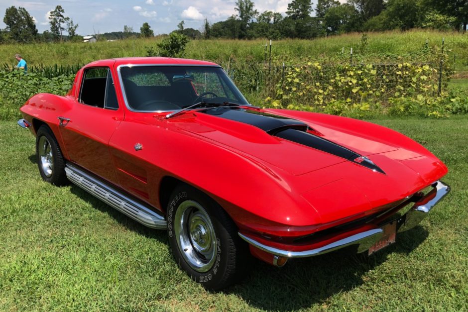 Red 1964 Corvette with L76 engine sitting in field