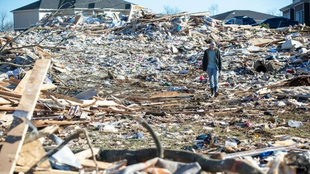 A Bowling Green resident walks thru the remains of his neighborhood following the horrific tornado that caused so much damage across the Bluegrass state.