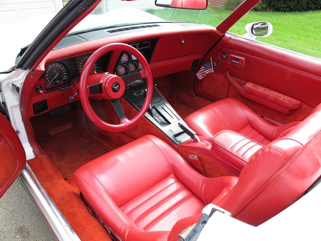 Pristine red interior of a 1980 Corvette