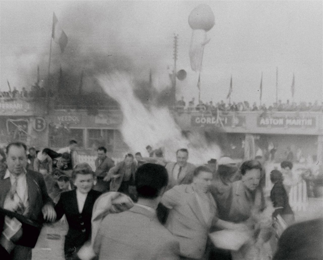 Spectators running from a fuel and magnesium fire at the 1955 Le Mans race