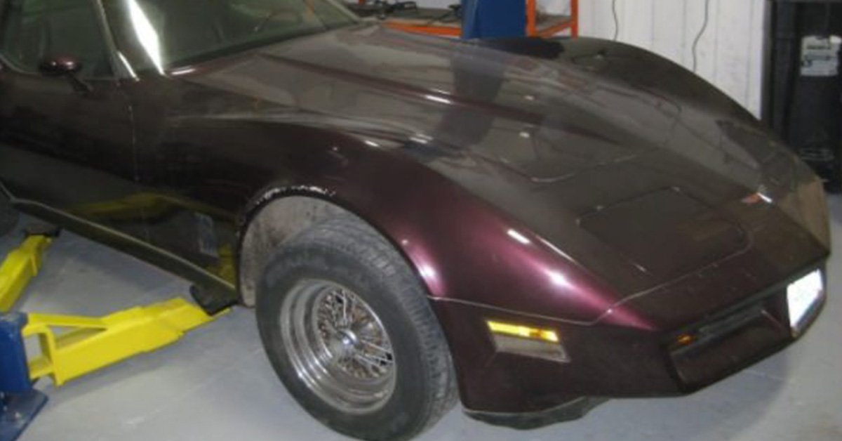 1968 burgundy Chevrolet Corvette on a car lift