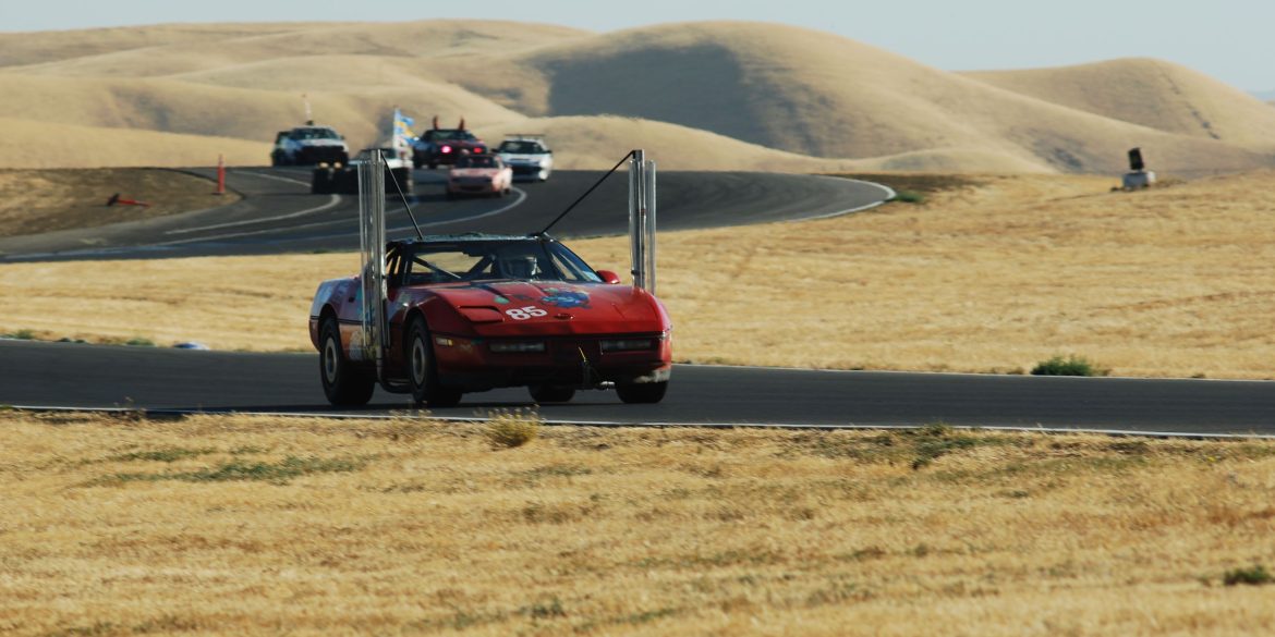Red Chevrolet Corvette C4 powered by biodiesel on a racetrack