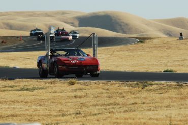 Red Chevrolet Corvette C4 powered by biodiesel on a racetrack