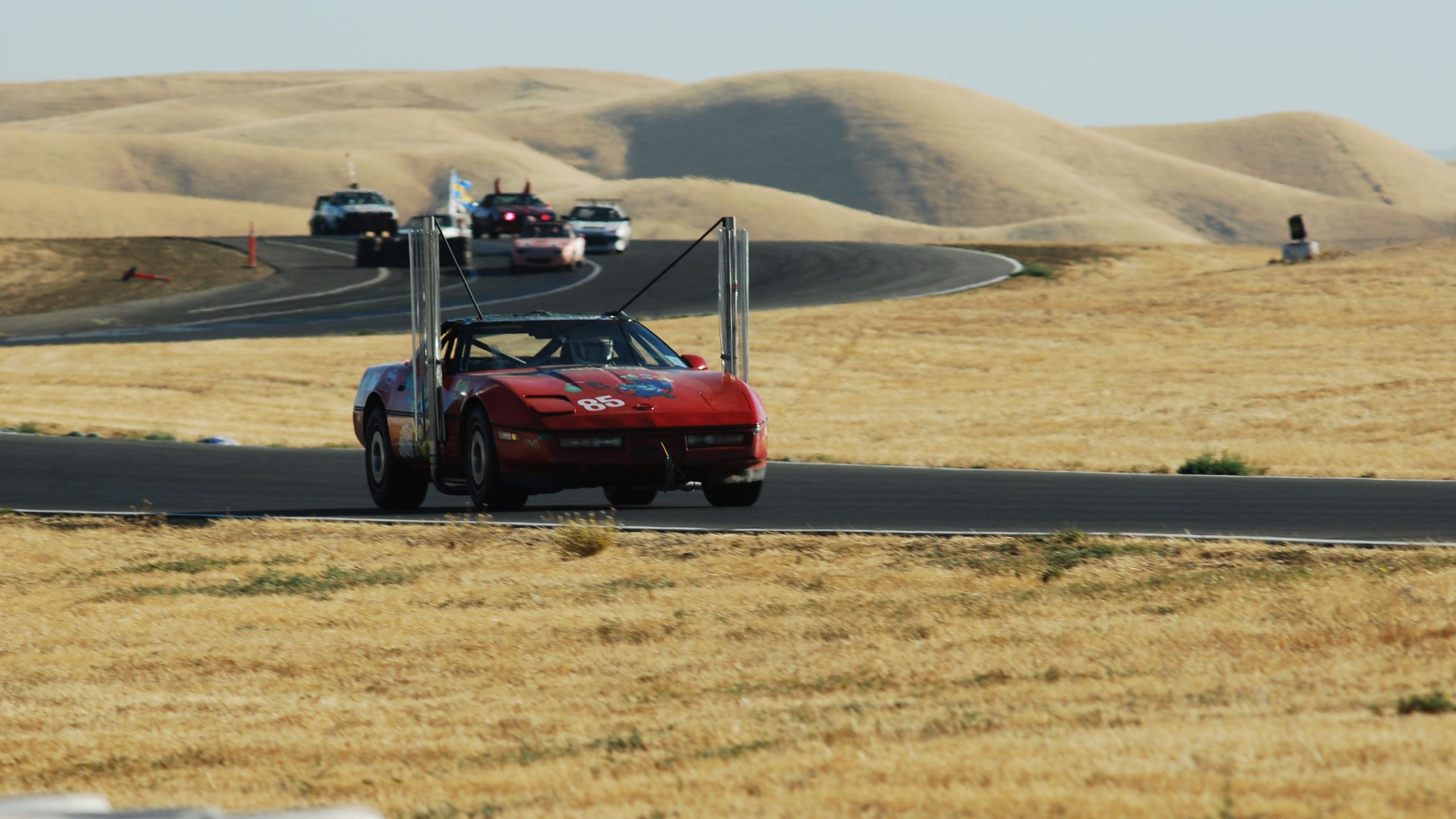 Red Chevrolet Corvette C4 powered by biodiesel on a racetrack