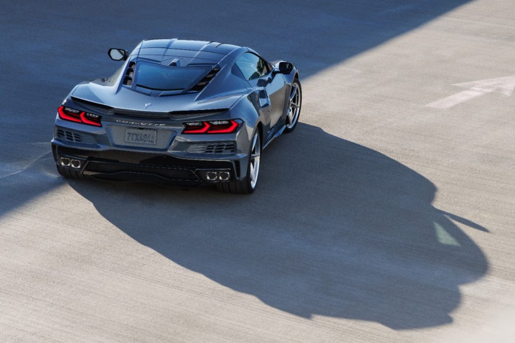 Rear 7/8 view of 2024 Chevrolet Corvette E-Ray 3LZ coupe in Seawolf Gray parked in a parking garage. Pre-production model shown. Actual production model may vary. Model year 2024 Corvette E-Ray available 2023. (Image courtesy of Chevrolet Media.)