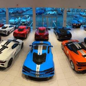 Various Corvette models parked inside a showroom