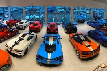 Various Corvette models parked inside a showroom