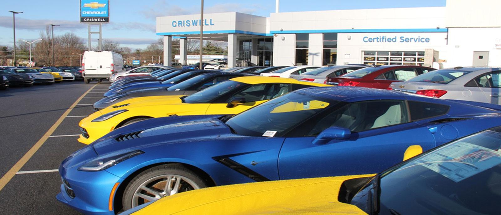 Corvettes parked outside a dealership lot