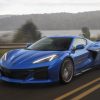 2023 Chevrolet Corvette Z06 in Elkhart Lake Blue Metallic driving down a road.