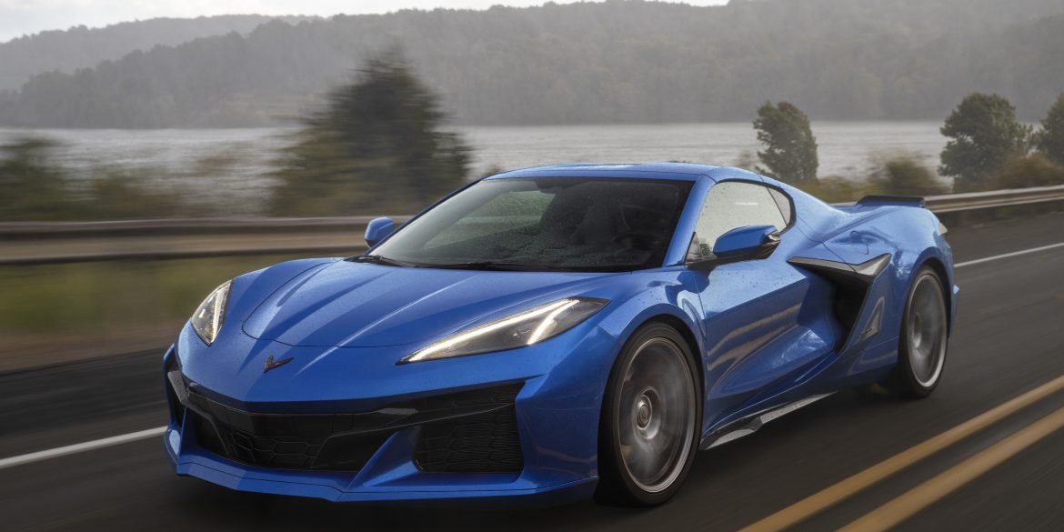 2023 Chevrolet Corvette Z06 in Elkhart Lake Blue Metallic driving down a road.