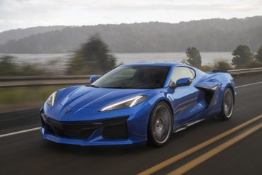 2023 Chevrolet Corvette Z06 in Elkhart Lake Blue Metallic driving down a road.