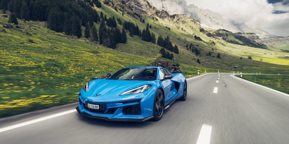 Front view of a 2025 Corvette E-Ray with mountain background