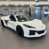 Three-quarter view of a 2024 white Corvette Z06 at a dealership