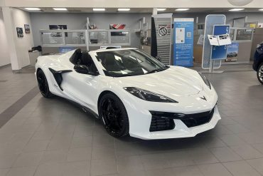 Three-quarter view of a 2024 white Corvette Z06 at a dealership