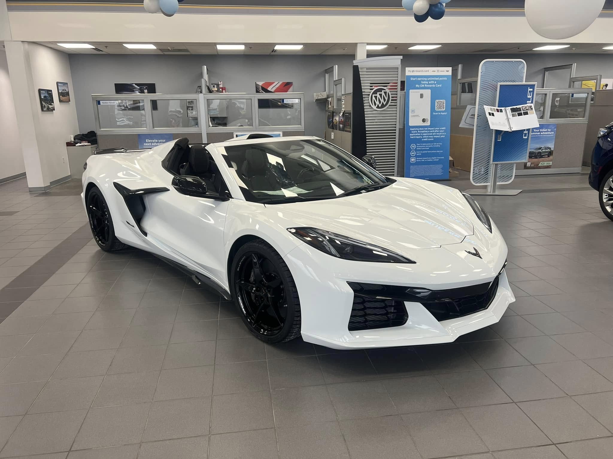 Three-quarter view of a 2024 white Corvette Z06 at a dealership