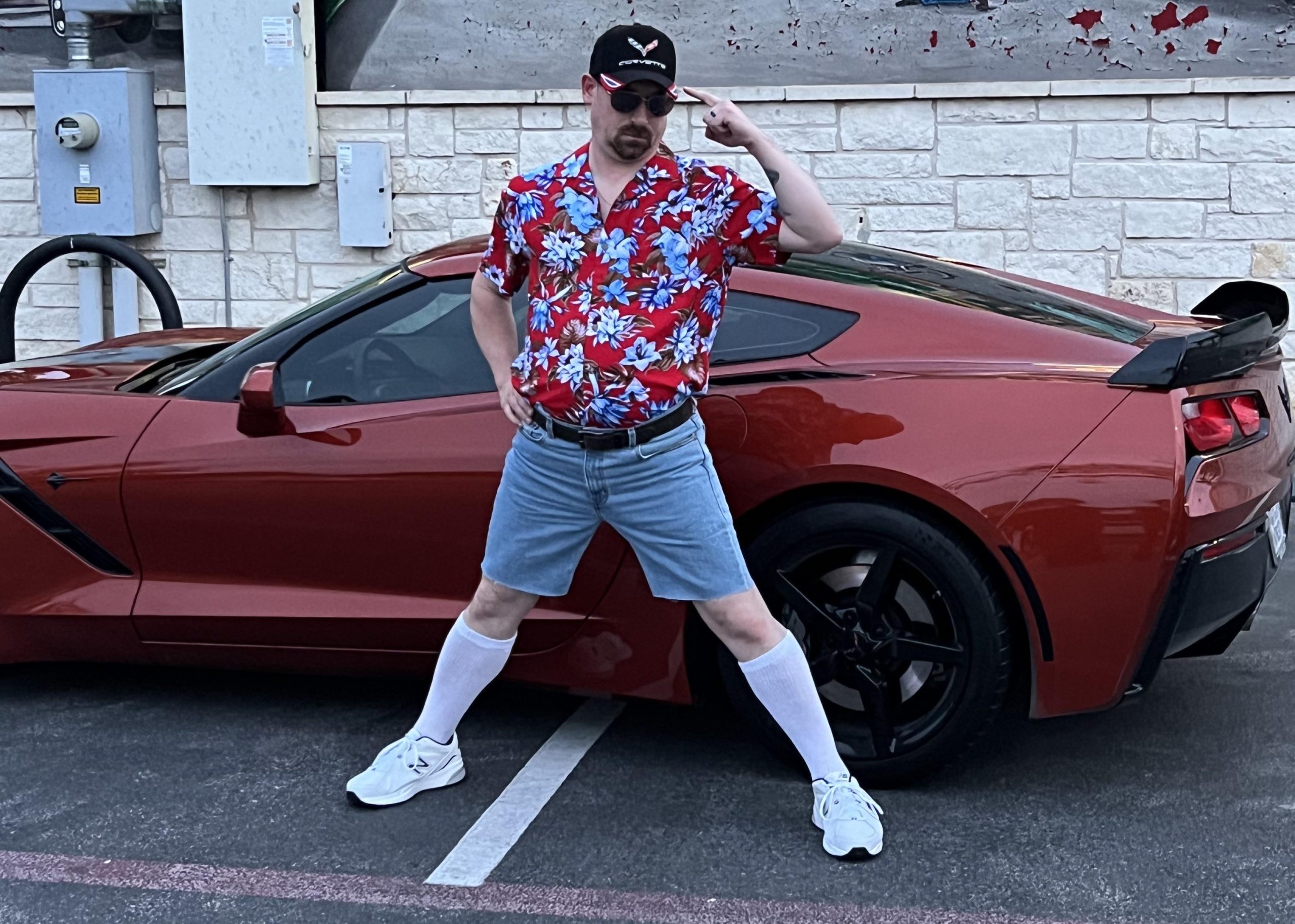 Man with "Corvette owner" outfit next to a C7 Corvette